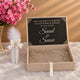 A personalized jewelry box with a black sign inside reading 'THEY DECIDED ON FOREVER IN THIS WORLD & JANNAH IN SHA ALLAH Saad & Sana' in elegant white script. The open beige box contains delicate gold and silver floral jewelry.