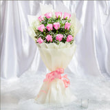 12 Pink Roses Bouquet arranged in packaging, close-up