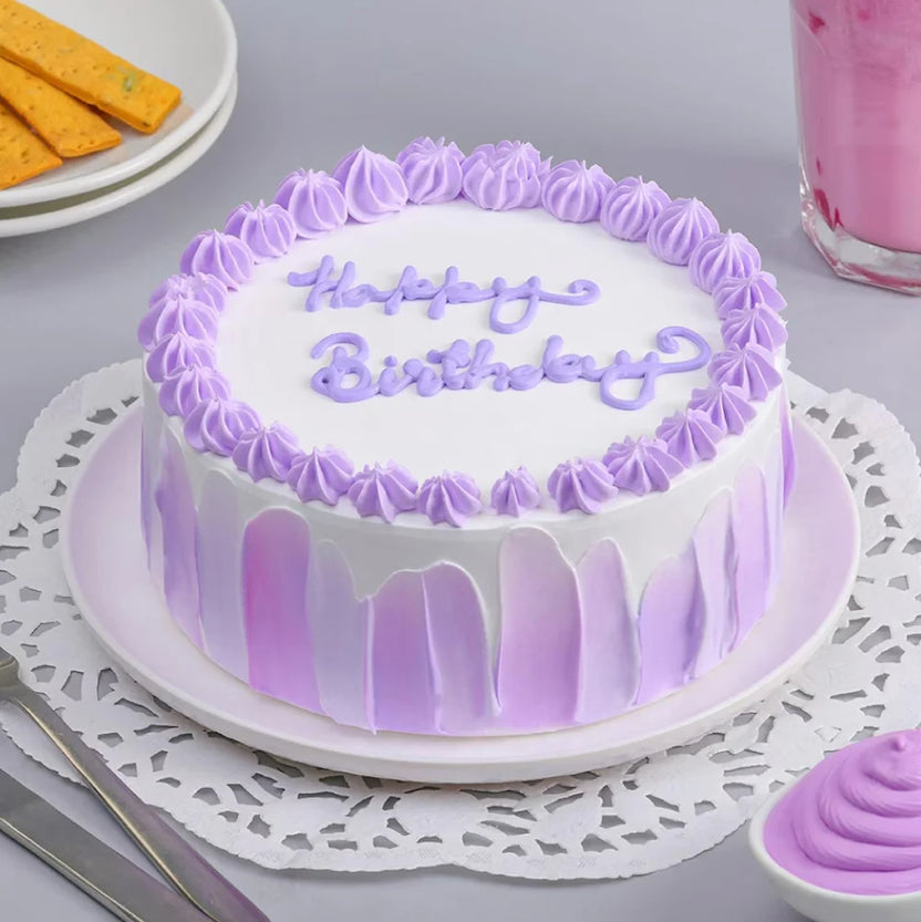 Floral Vanilla Cream Cake - Elegant Dessert with lavender floral piping and pastel purple icing drips, ideal for birthdays and special occasions. Main image