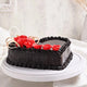 Side view of Toothsome Chocolate Cake featuring textured chocolate frosting and red rose toppings, a decadent dessert for special occasions.