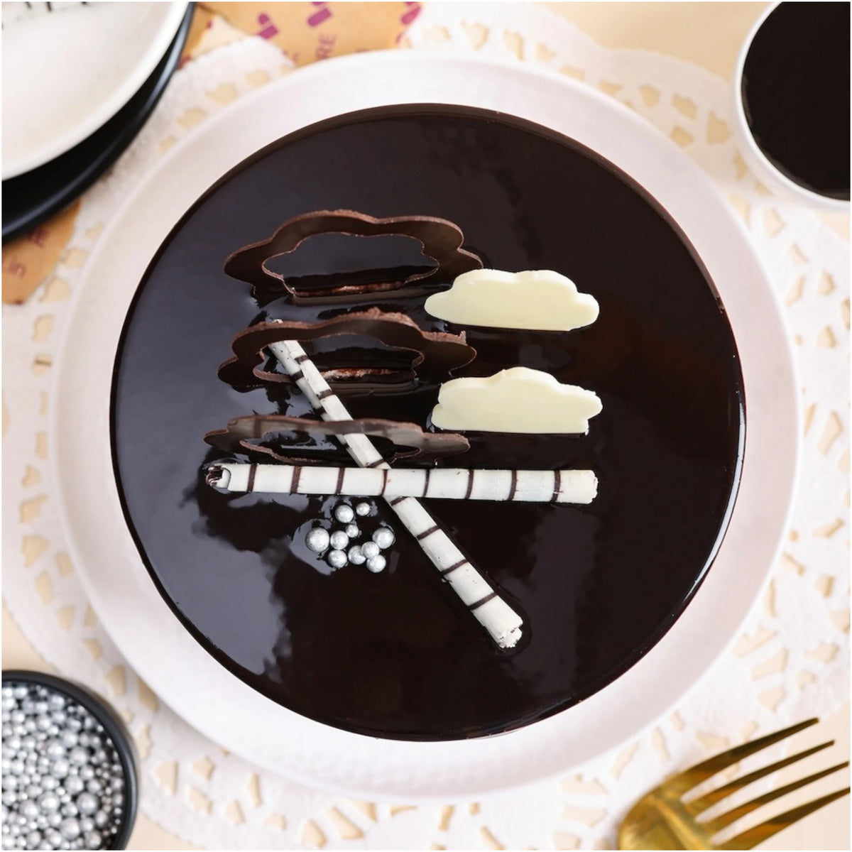 Top view of Mouth Melting Chocolate Cake - Indulgent Layers featuring dark chocolate glaze, striped chocolate sticks, and cloud-shaped toppers.