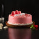 Fudge Cream Cake - Rich Layered Dessert | Chocolate Fudge with pink glaze, white cream swirls, and red macarons on a wooden base.