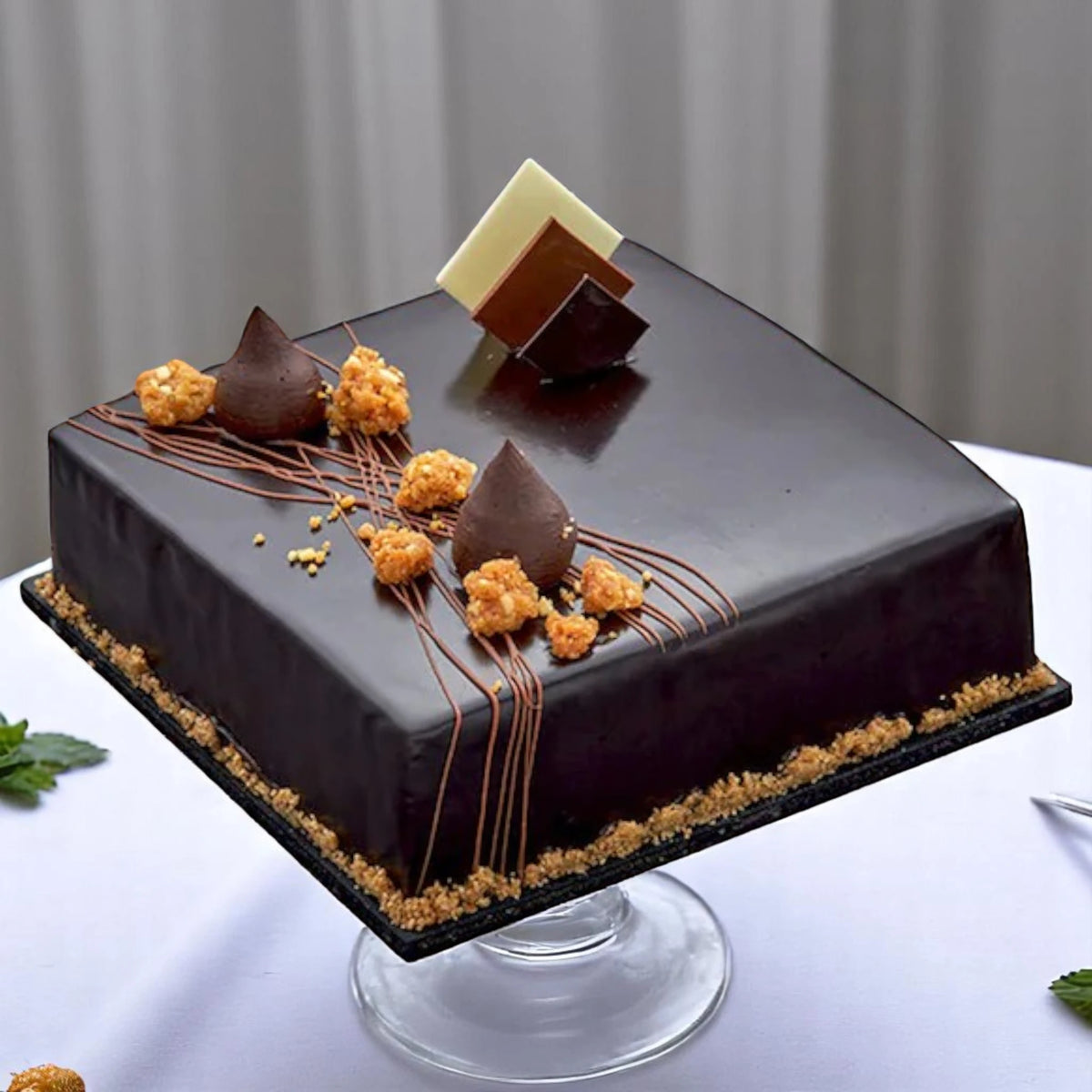 Square Belgium Chocolate Truffle Cake featuring rich Belgian chocolate, elegant garnish, and smooth finish. Perfect for celebrations and same day delivery.