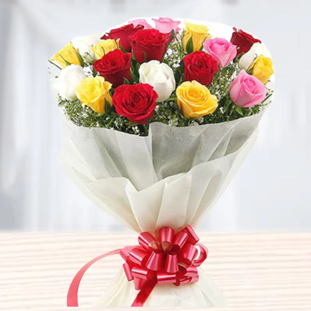 Modern Romance - Premium Mixed Rose Bouquet with red, yellow, white, and pink roses, wrapped in white paper and tied with a red ribbon.