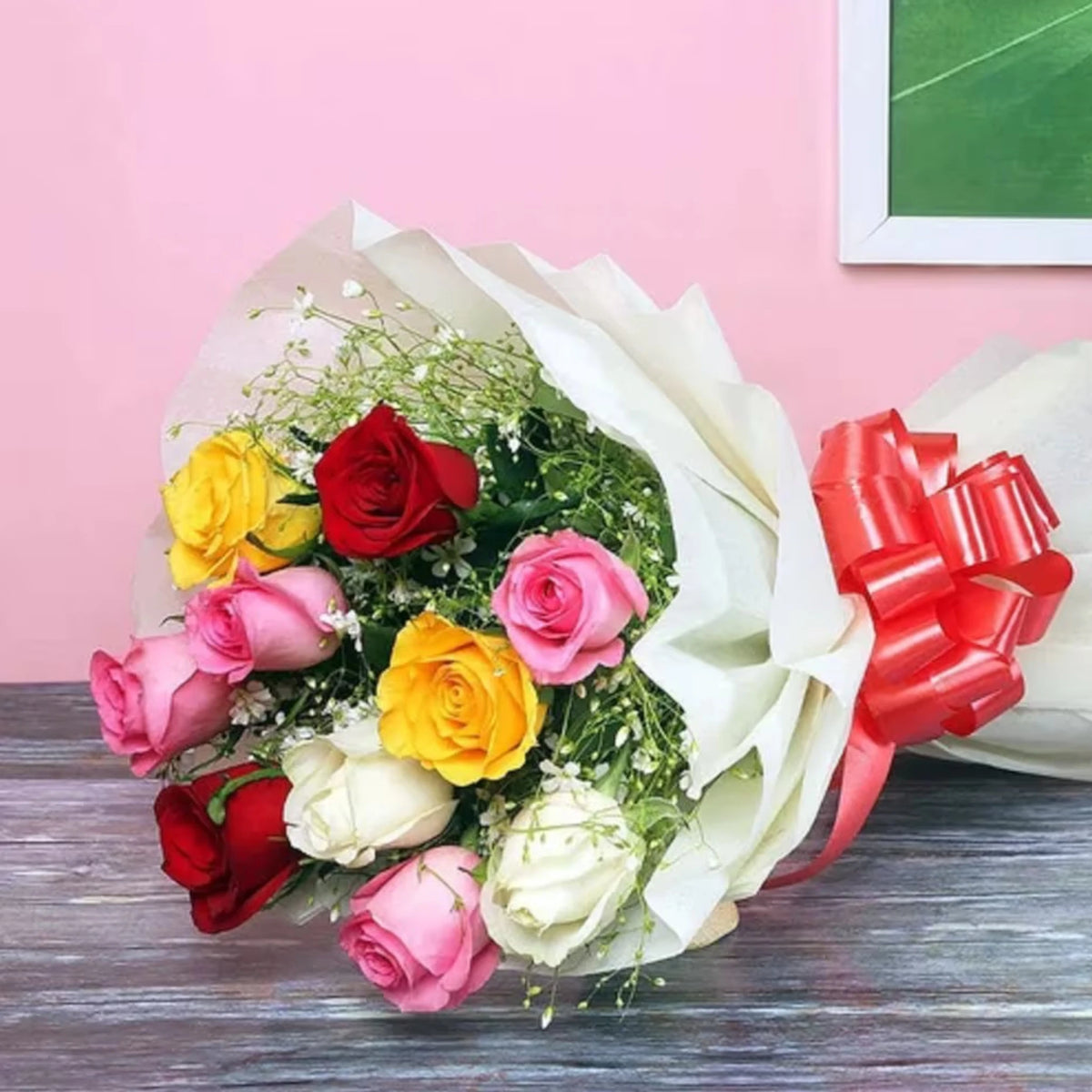 Modern Romance - Stylish Mixed Rose Arrangement with 10 premium roses in vibrant colors, wrapped in white paper and finished with an orange bow.