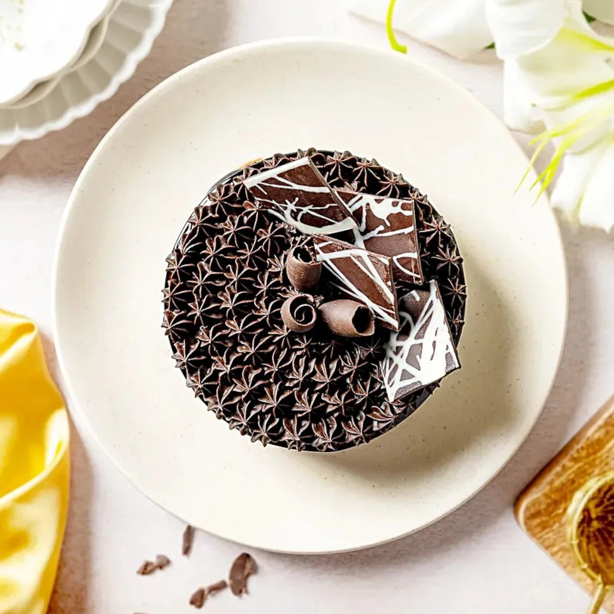 Top view of Fudge Brownie Cake featuring dense chocolate frosting and artistic chocolate decorations. Perfect chocolaty indulgence for dessert lovers.
