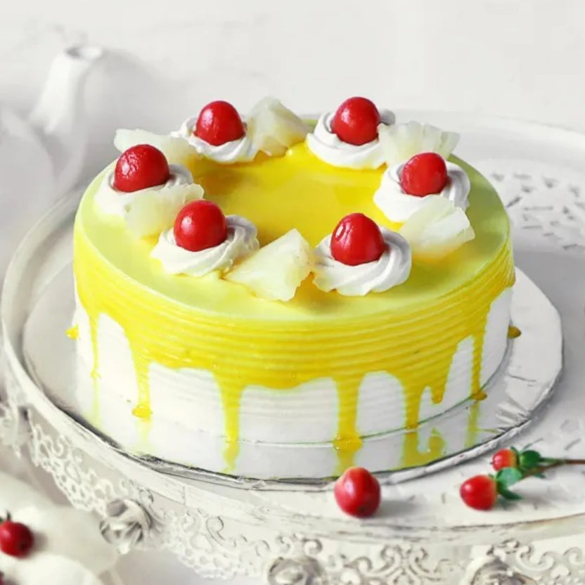 Delicious Pineapple Cake topped with whipped cream, real pineapple chunks, and cherries. Perfect tropical dessert for birthdays or anniversaries. Main image