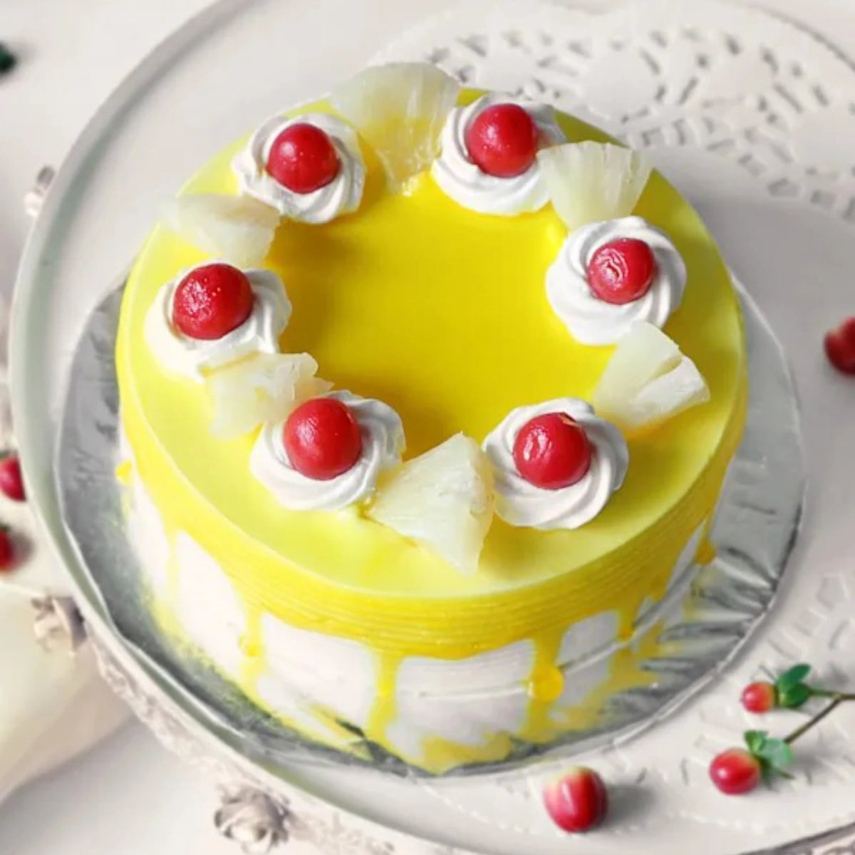 Top view of Delicious Pineapple Cake decorated with real pineapple chunks and cherries. A refreshing round cake for celebrations and gifting.