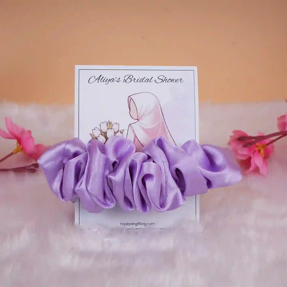 Lavender satin scrunchie favor on custom bridal shower card with floral and bride artwork, elegant gift for wedding celebrations.
