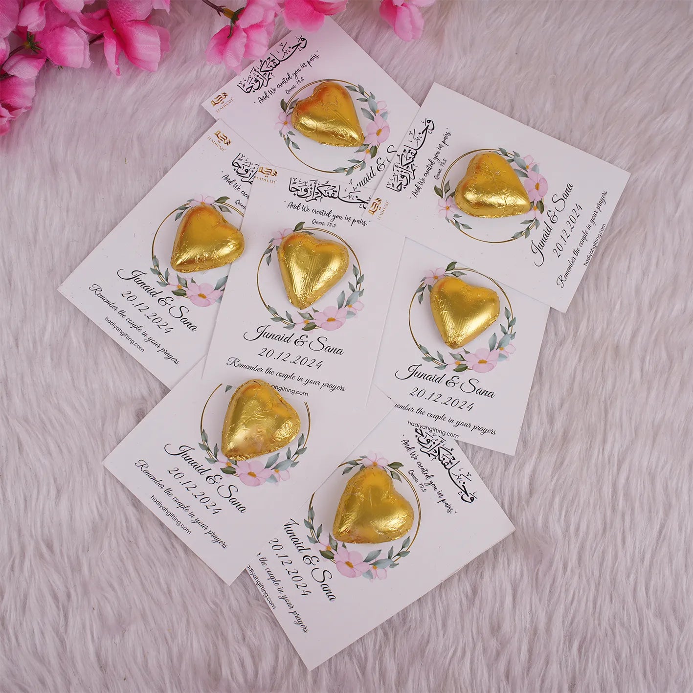 Customized chocolate wedding favors for Nikah featuring gold heart-shaped chocolates on floral cards with Islamic quotes and couple's names. Main image