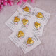 Customized chocolate wedding favors for Nikah featuring gold heart-shaped chocolates on floral cards with Islamic quotes and couple's names.