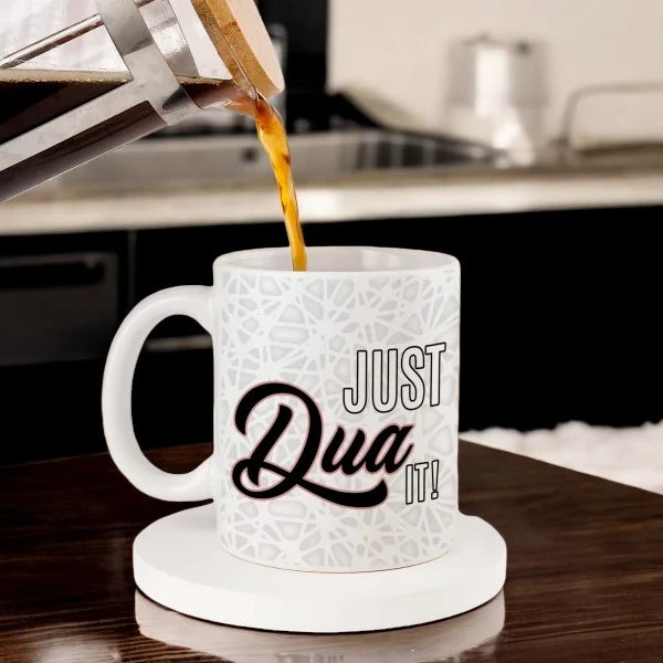 Dua Mug (350ML) - Personalized Islamic gift mug with 'Just Dua It!' text, ideal for Ramadan or Eid, shown being filled with coffee in a kitchen. Main image