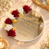 Personalized gold nikah mirror plaque with a pearl border, floral accents and gold lettering, photographed at an angle.