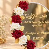 Floral gold nikah mirror plaque displayed on a stand with pearl trim and elegant wedding calligraphy.