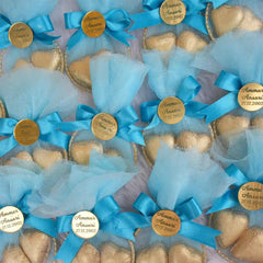 Multiple blue Aqiqah Golden Hearts Favors with gold chocolates and custom name tags, designed for weddings or aqiqah celebrations.
