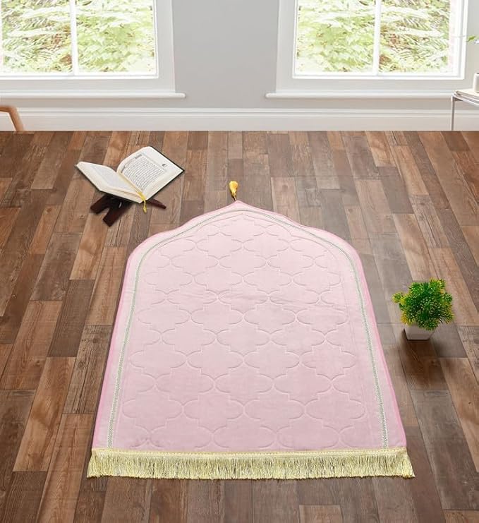 Personalized Dome Janamaz with Name in soft pink velvet, displayed in a serene prayer room with Quran and greenery, ideal for gifting. Main image