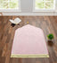 Personalized Dome Janamaz with Name in soft pink velvet, displayed in a serene prayer room with Quran and greenery, ideal for gifting.