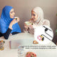 Two women enjoying tea while wearing Noor Zikr Ring - Smart Tasbeeh. USB charging shown for convenience and portability.