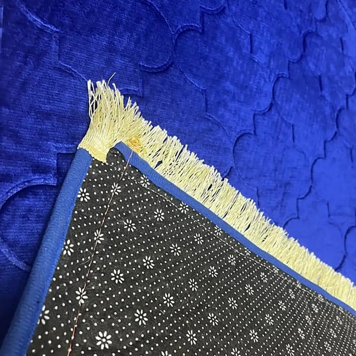Close-up of Blue Dome Janamaz showing soft velvet texture, gold fringe, and non-slip backing. Premium personalized prayer rug.