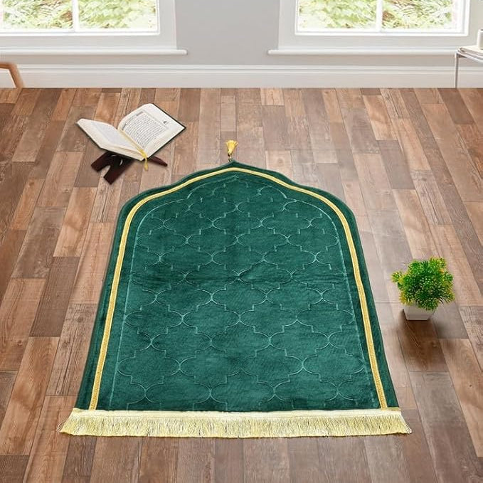 Green velvet prayer mat with gold trim displayed in a serene room, part of the Bridal Hamper - The Bling Collection for spiritual wedding gifts.