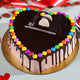 Sprinkled Gems Cake - Colorful Gems Cake with heart shape, chocolate glaze, and rainbow candy topping, ideal for parties and same day delivery.