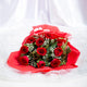 Blooming Insight - Bright Bloom Bouquet featuring 10 fresh red roses with baby's breath and greenery, laid on red wrapping over white fabric.