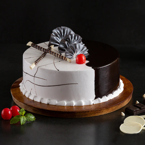 Choco Vanilla Cream Cake - Chocolate Vanilla Cake with dual-tone frosting, chocolate garnish, cherry topping on wooden base, ideal for celebrations. Main image