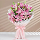 7 Pink Asiatic Lilies Bouquet arranged in packaging, close-up