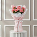 7 Pink Carnations Flower Bouquet arranged in packaging, close-up