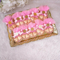 Tray of pink Aqiqah Golden Hearts Favors with gold chocolates and custom tags, ideal for nikah or wedding celebrations.