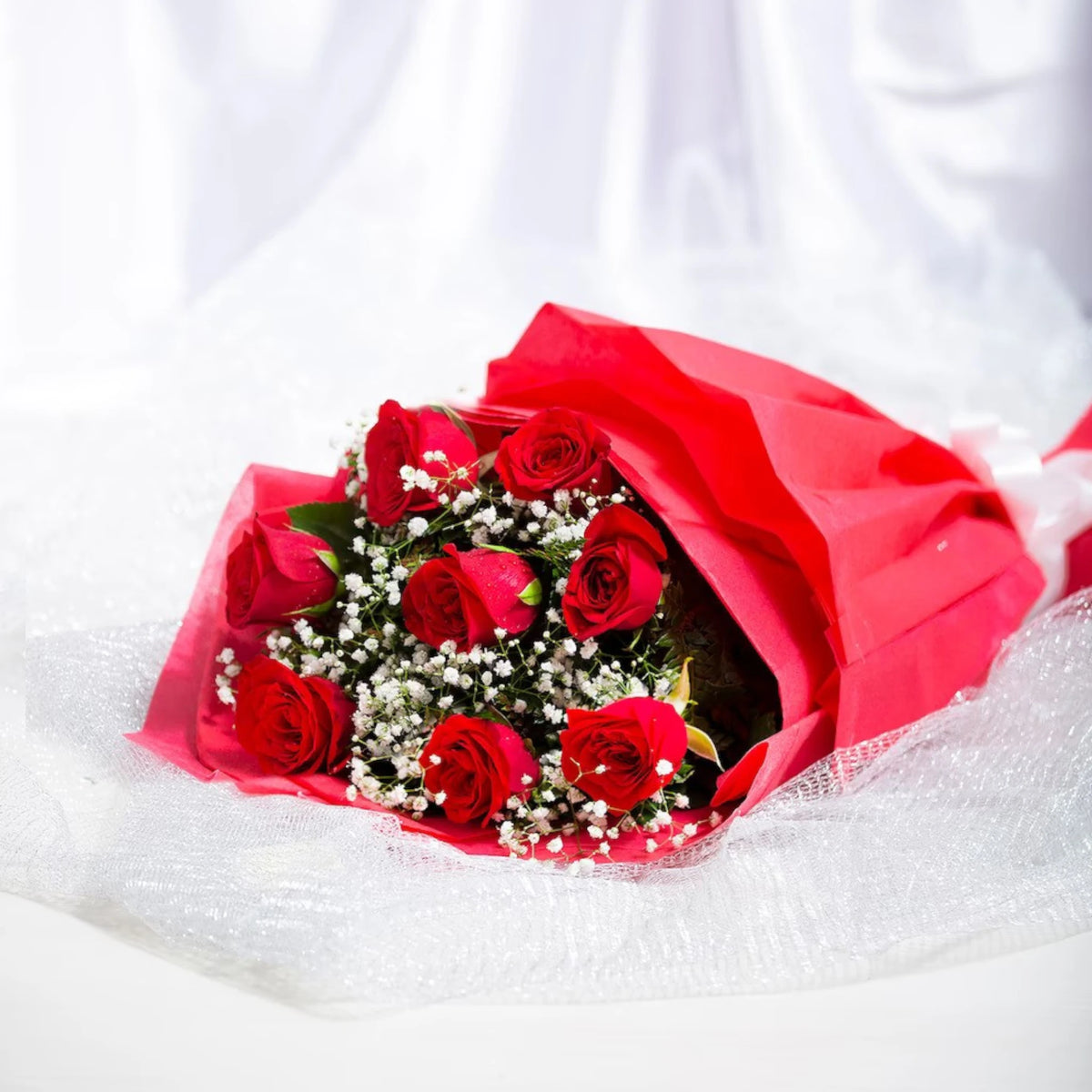 Red Roses Bouquet with 8 fresh roses and baby's breath, wrapped in red paper. Ideal for romantic occasions and same day delivery gifts.