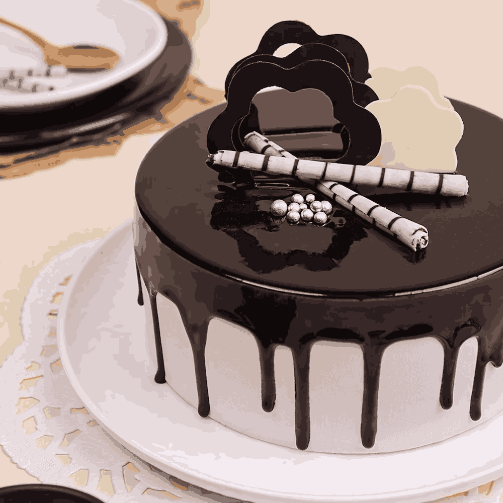 Side angle of Mouth Melting Chocolate Cake - Indulgent Layers showing rich chocolate drip, elegant toppings, and smooth round finish.