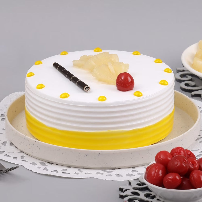 Yummy Pineapple Cake - Tropical Pineapple Cake with whipped cream, yellow frosting, cherry, and pineapple bits, perfect for celebrations. Main image