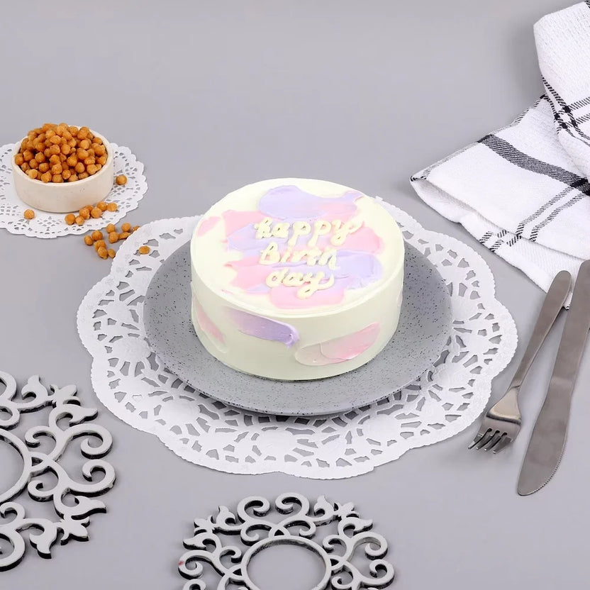 Mini Pineapple Cake (300 gm) - Tropical Delight with pastel frosting on a grey plate, ideal for birthdays and same day delivery. Main image