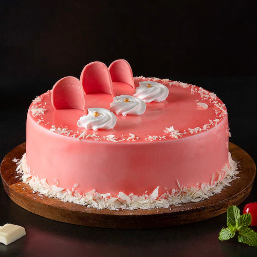Fudge Cream Cake - Rich Layered Dessert | Chocolate Fudge featuring pink frosting, white chocolate shavings, and decorative toppings.