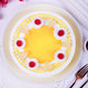 Top view of Sunshine Pineapple Cake featuring vibrant yellow glaze, red cherries, and pineapple slices on soft sponge layers for a tropical treat.