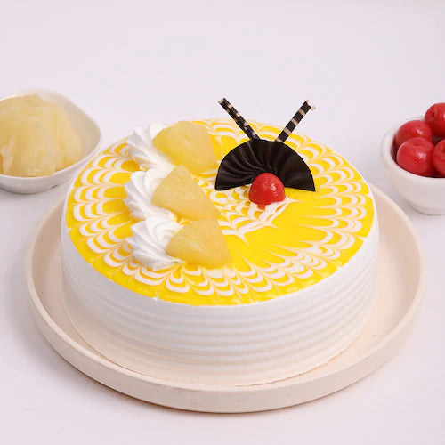 Tropical Bliss Pineapple Cake with yellow glaze, whipped cream, pineapple chunks, and cherry topping, ideal for summer desserts and celebrations. Main image