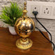 Electric Serene Essence Bakhoor Burner in gold finish placed on wooden surface, blends traditional elegance with modern functionality for home fragrance.