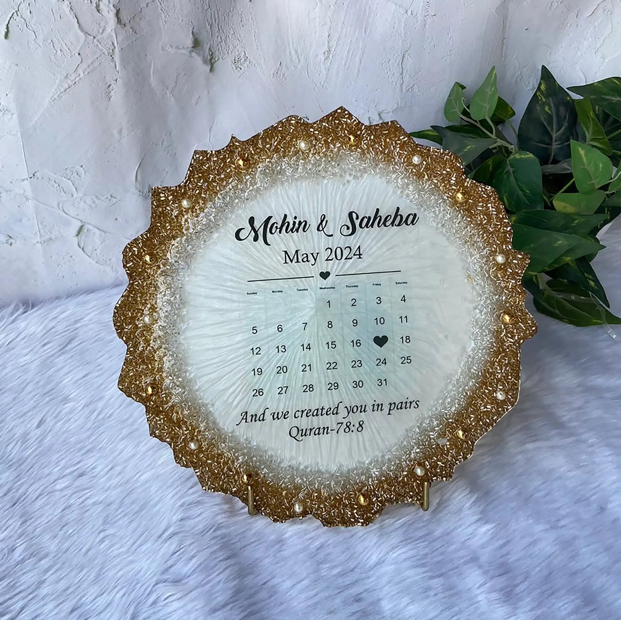 Calendar Couple Frame - Islamic Gift featuring names Mohin & Saheba with May 2024 calendar and Quran 78:8 verse. Elegant gold-edged decor piece. Main image