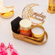 Luxe Ramadan Gift Hamper with black tasbih box, roasted almonds, candle, and Ramadan Mubarak crescent decor in elegant gold tray.