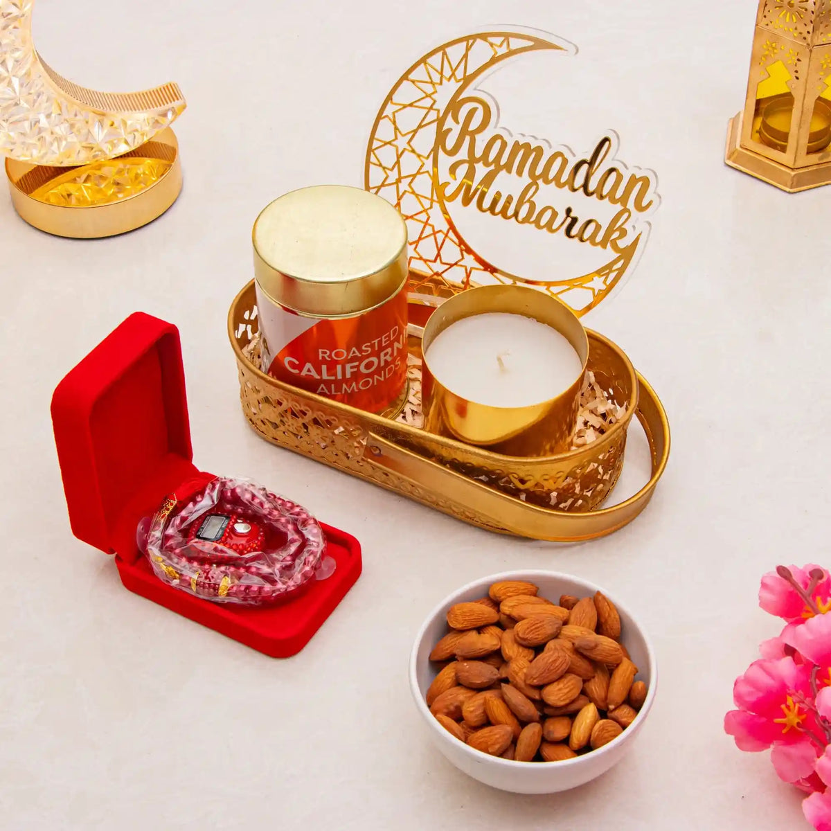Decorative setup with candles, nuts, and 'Ramadan Mubarak' sign on a light background