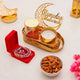 Decorative setup with candles, nuts, and 'Ramadan Mubarak' sign on a light background