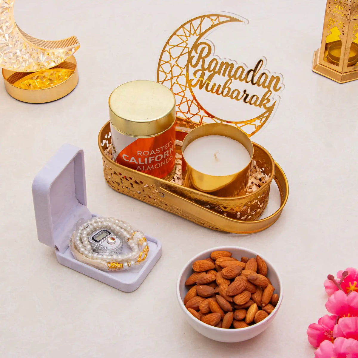 Decorative items for Ramadan with candles, cookies, and a 'Ramadan Mubarak' sign.