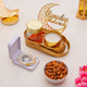 Decorative items for Ramadan with candles, cookies, and a 'Ramadan Mubarak' sign.