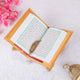 Golden Quran with green bordered Arabic script on wooden stand, part of the Golden Sawab-e-Jariya Bling Quran Gift Set for Eid and weddings.