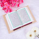 Open book with Arabic text on a light background with flowers
