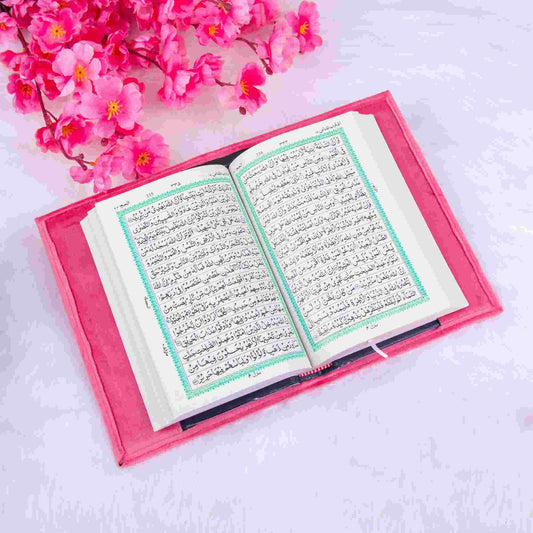 Open Quran with green border text in pink velvet cover, included in the Sawab-e-Jariya bridal gift hamper. Perfect for Nikkah gifting.