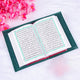 Open Quran with green velvet cover from the Green Sequence Tilawat-e-Quran set, displayed on a soft white surface.