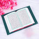 Open book with Arabic text on a white background with pink flowers