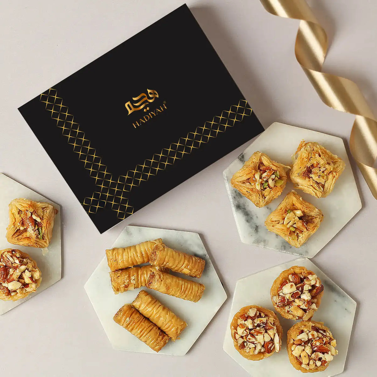 Delicious Assorted Baklava - Buy Online | 200g & 400g gift box with mixed nut-filled baklava pieces on marble trays, perfect for festive gifting.